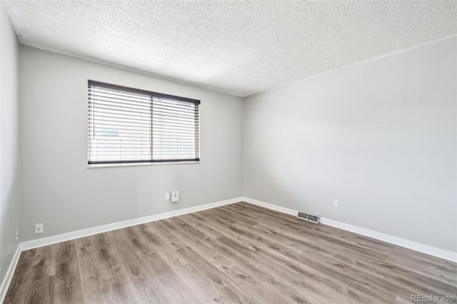 14590 E 13th Ave, Aurora, CO 80011 - unfurnished room with wood finished floors and a textured ceiling