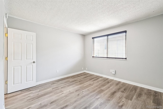 14590 E 13th Ave, Aurora, CO 80011 - empty room featuring wood finished floors and a textured ceiling