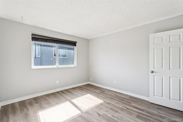 14590 E 13th Ave, Aurora, CO 80011 - spare room featuring wood finished floors and a textured ceiling