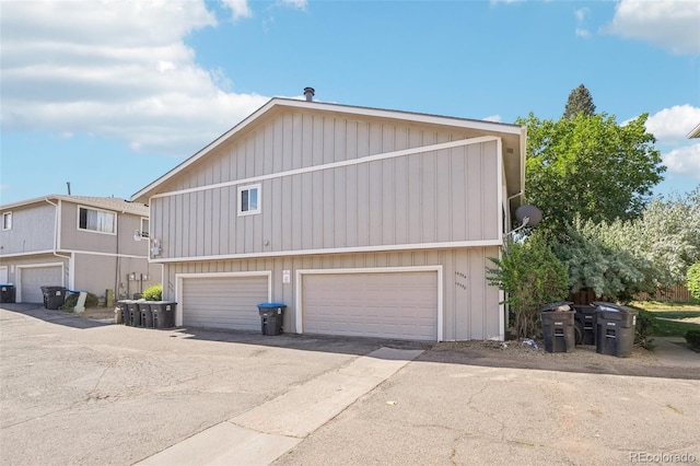 14590 E 13th Ave, Aurora, CO 80011 - view of side of home featuring a garage and board and batten siding