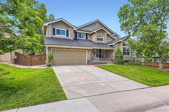 9743 Chanteclair Cir, Highlands Ranch, CO 80126 - view of front of house featuring stone siding, an attached garage, concrete driveway, and a gate