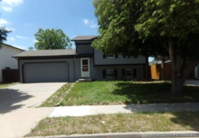 1889 S Flanders Way, Aurora, CO 80017 - view of front of house featuring an attached garage, driveway, and a front yard