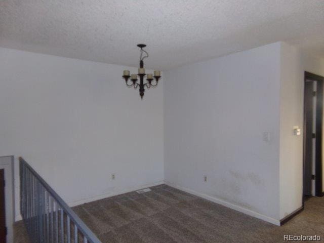 1889 S Flanders Way, Aurora, CO 80017 - unfurnished room featuring carpet, a chandelier, and a textured ceiling