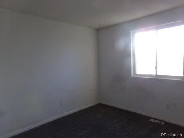 1889 S Flanders Way, Aurora, CO 80017 - empty room featuring dark carpet and baseboards