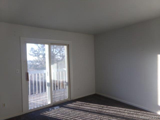 1889 S Flanders Way, Aurora, CO 80017 - unfurnished room with baseboards and dark colored carpet