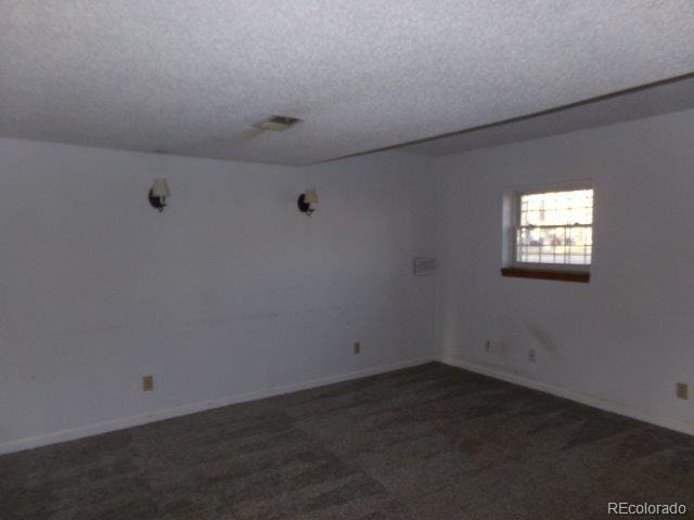 1889 S Flanders Way, Aurora, CO 80017 - carpeted spare room featuring a textured ceiling and baseboards
