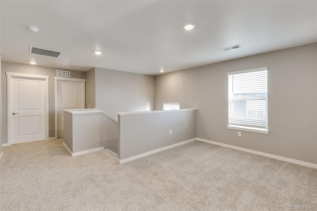 spare room with light colored carpet