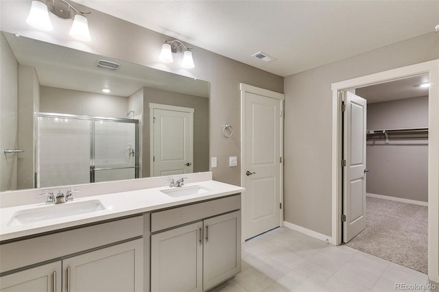 bathroom featuring an enclosed shower and vanity