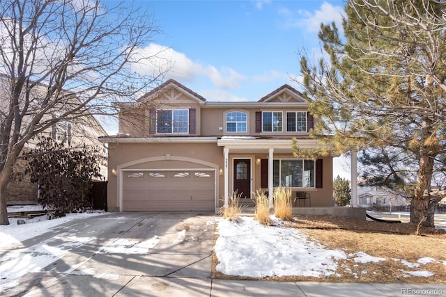 view of front of home featuring an attached garage, covered porch, concrete driveway, and stucco siding