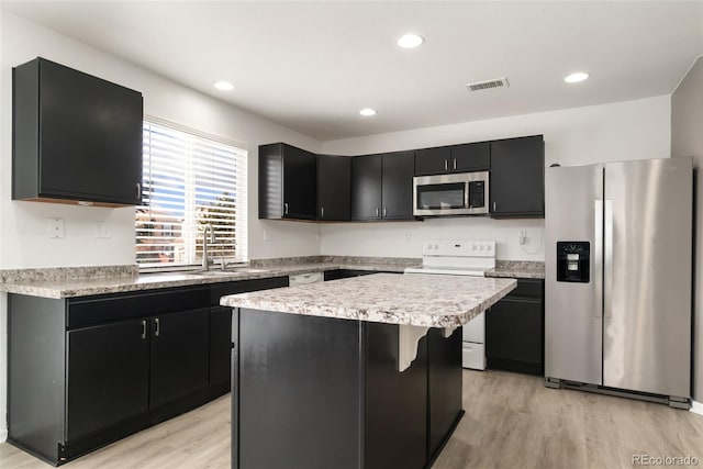 kitchen featuring light wood-style flooring, visible vents, light countertops, appliances with stainless steel finishes, and dark cabinetry