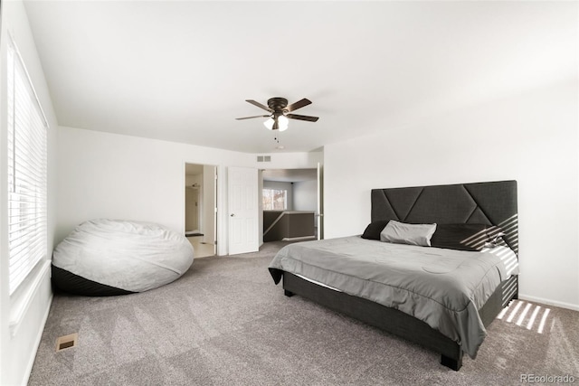 carpeted bedroom featuring visible vents and a ceiling fan