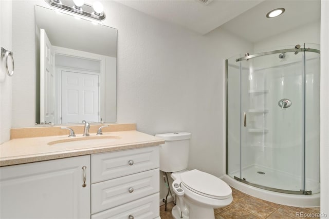 bathroom with toilet, a stall shower, tile patterned floors, and vanity