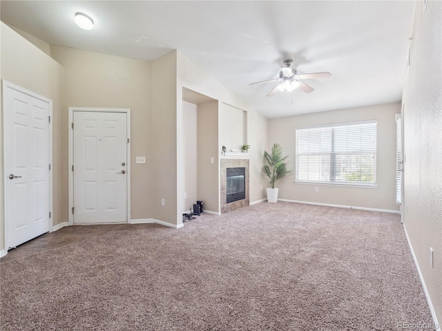 9142 Lodestar Ln Unit 305, Parker, CO 80134 - unfurnished living room with a ceiling fan, carpet flooring, and a tile fireplace