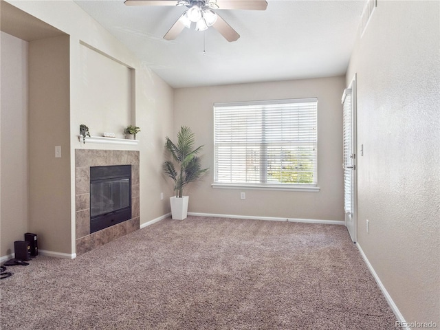 9142 Lodestar Ln Unit 305, Parker, CO 80134 - unfurnished living room with a tile fireplace, carpet flooring, and a ceiling fan