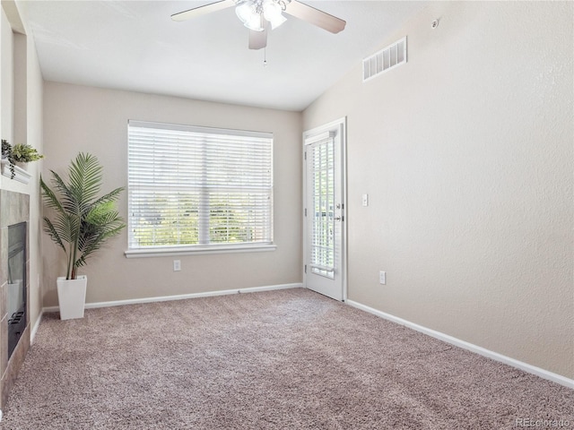 9142 Lodestar Ln Unit 305, Parker, CO 80134 - carpeted empty room featuring a ceiling fan and a tile fireplace