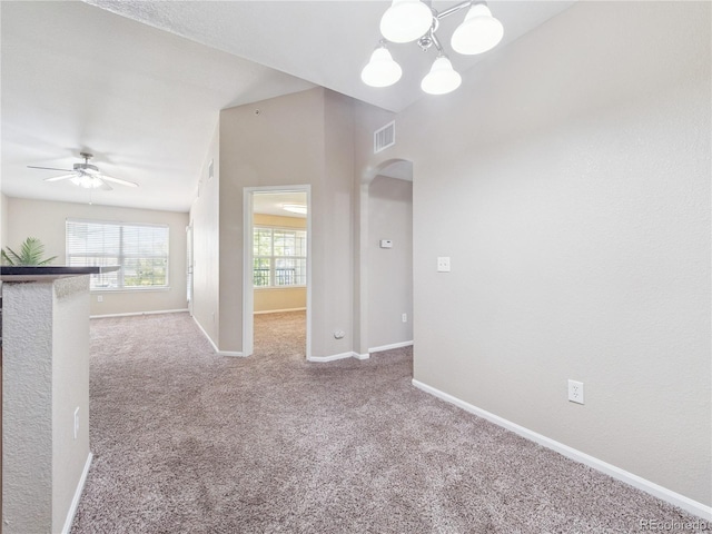 9142 Lodestar Ln Unit 305, Parker, CO 80134 - empty room featuring arched walkways, carpet flooring, a ceiling fan, and a chandelier
