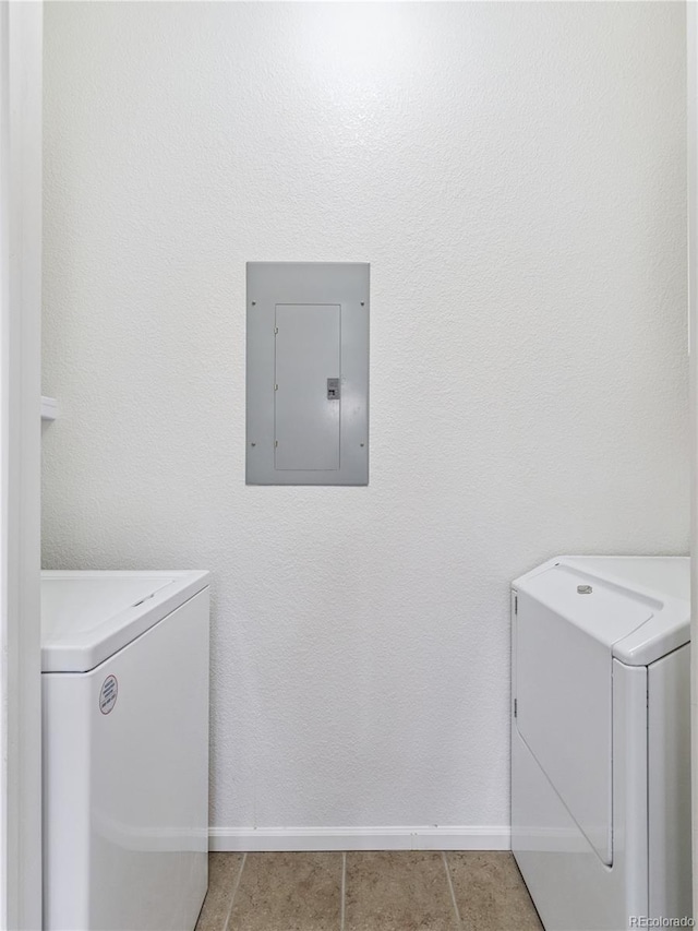 9142 Lodestar Ln Unit 305, Parker, CO 80134 - laundry area with electric panel, washing machine and dryer, and light tile patterned flooring