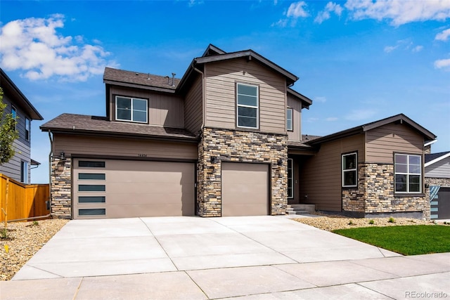 view of front of home featuring an attached garage, fence, and concrete driveway