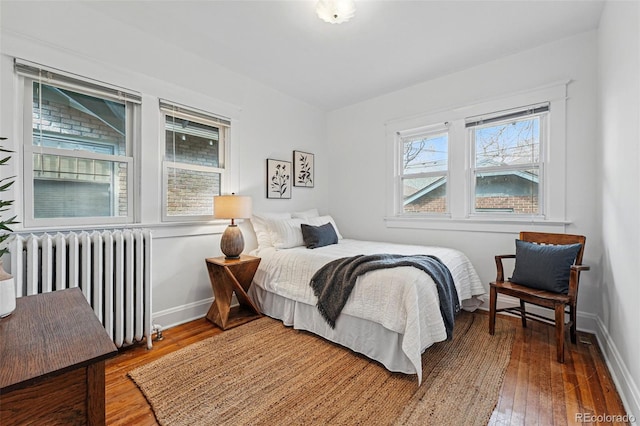 618 Adams St, Denver, CO 80206 - bedroom featuring radiator, hardwood / wood-style flooring, and baseboards