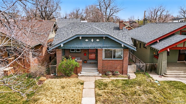 618 Adams St, Denver, CO 80206 - view of front of property featuring a shingled roof, brick siding, and a chimney