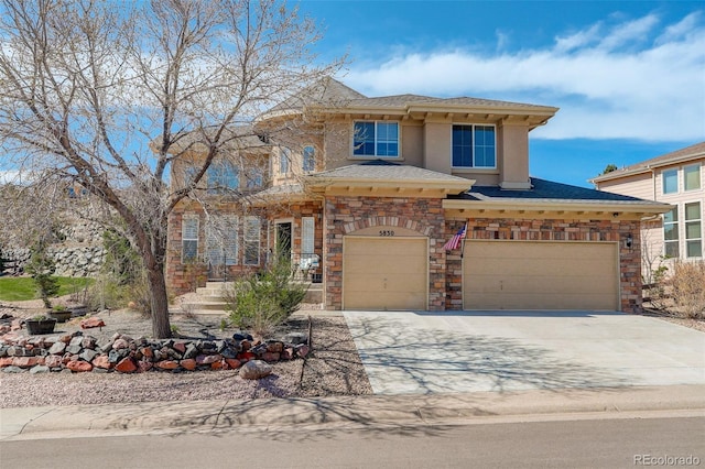 5830 Jasper Pointe Cir, Castle Pines, CO 80108 - view of front of house featuring driveway, stucco siding, stone siding, and a garage