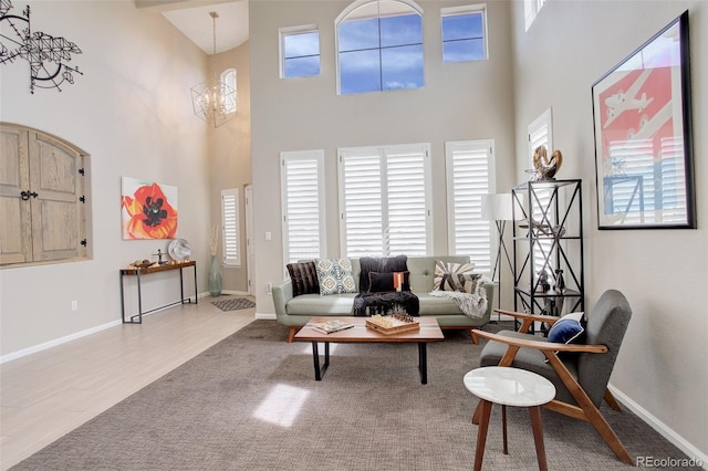 5830 Jasper Pointe Cir, Castle Pines, CO 80108 - living area featuring baseboards, a high ceiling, and a chandelier