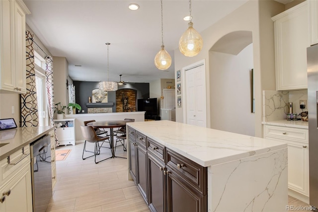 5830 Jasper Pointe Cir, Castle Pines, CO 80108 - kitchen featuring stainless steel dishwasher, arched walkways, backsplash, a center island, and pendant lighting