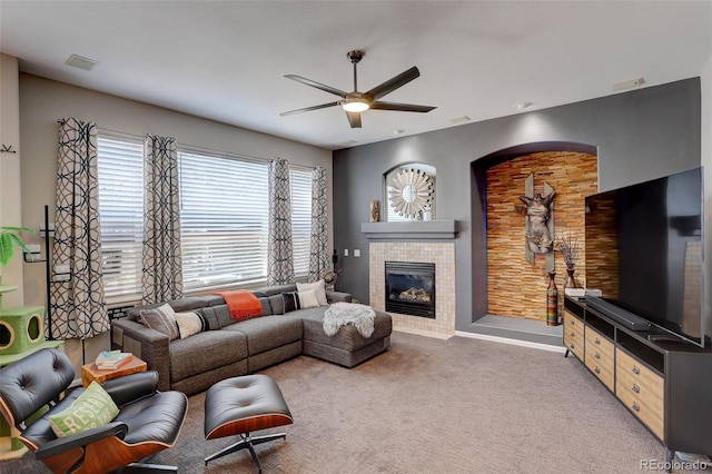 5830 Jasper Pointe Cir, Castle Pines, CO 80108 - carpeted living area featuring a ceiling fan, a tiled fireplace, and baseboards