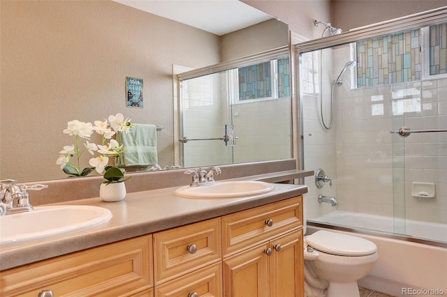 5830 Jasper Pointe Cir, Castle Pines, CO 80108 - bathroom with double vanity, toilet, combined bath / shower with glass door, healthy amount of natural light, and a textured wall