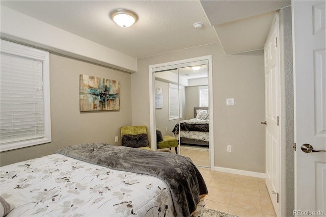 5830 Jasper Pointe Cir, Castle Pines, CO 80108 - bedroom with a closet, light tile patterned floors, and baseboards