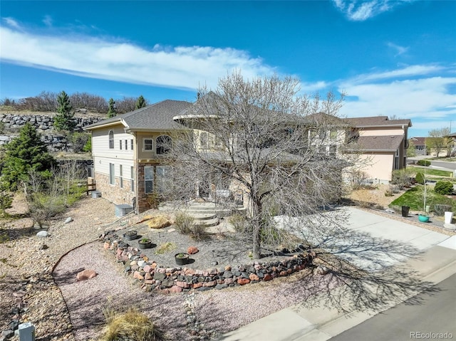 5830 Jasper Pointe Cir, Castle Pines, CO 80108 - view of front facade featuring stone siding and a shingled roof