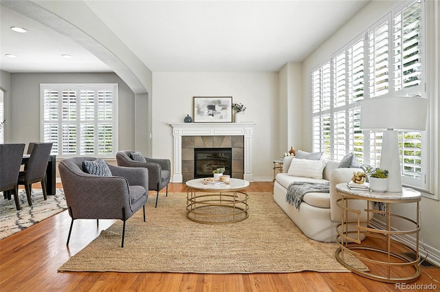 7527 E Severn Pl, Denver, CO 80230 - living room featuring wood finished floors, healthy amount of natural light, a tile fireplace, and recessed lighting