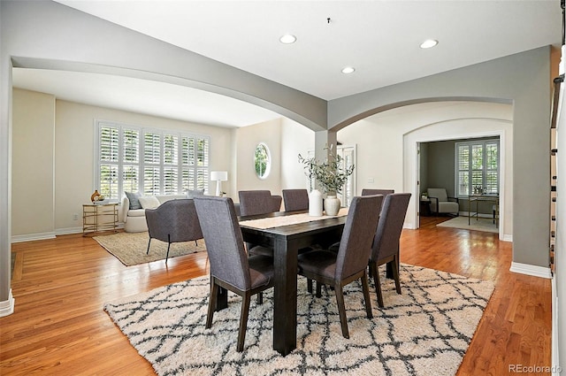 7527 E Severn Pl, Denver, CO 80230 - dining area with arched walkways, light wood-type flooring, and recessed lighting