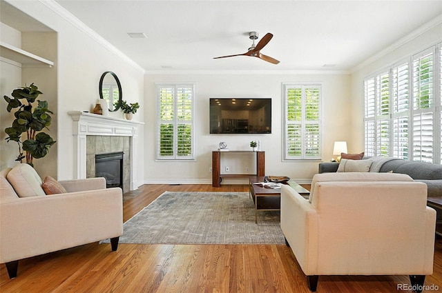 7527 E Severn Pl, Denver, CO 80230 - living room with ceiling fan, a fireplace, ornamental molding, and wood finished floors