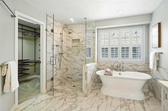 7527 E Severn Pl, Denver, CO 80230 - bathroom featuring a marble finish shower, a soaking tub, marble look tile flooring, and recessed lighting
