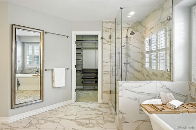 7527 E Severn Pl, Denver, CO 80230 - bathroom featuring marble finish floors, a marble finish shower, a spacious closet, a freestanding tub, and recessed lighting