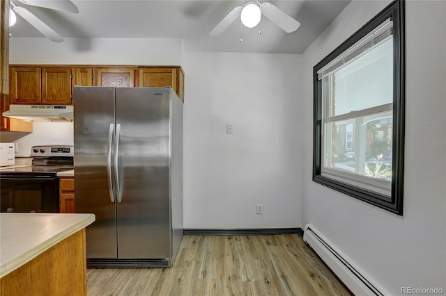 kitchen with a baseboard radiator, under cabinet range hood, electric stove, freestanding refrigerator, and brown cabinetry