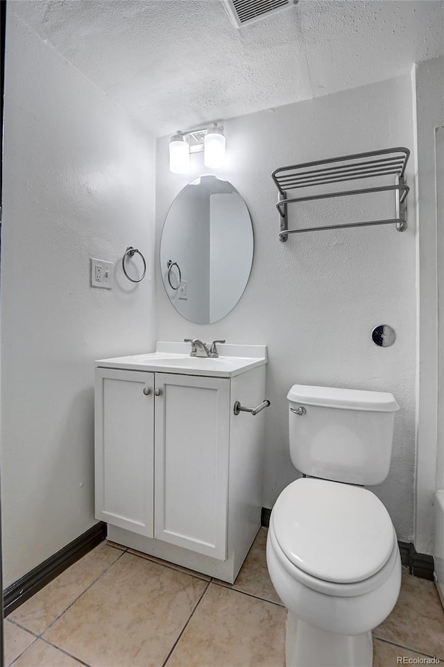 full bathroom featuring toilet, tile patterned flooring, baseboards, and vanity