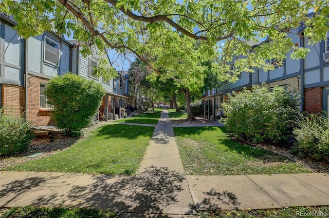 view of community with a residential view and a yard