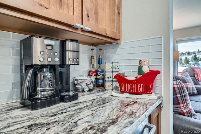 kitchen with tasteful backsplash and light stone countertops