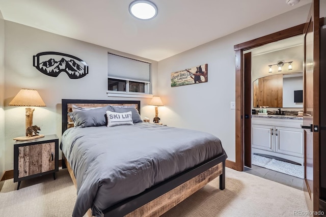 carpeted bedroom with sink and connected bathroom