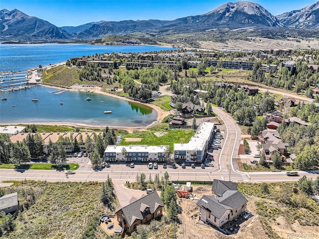 drone / aerial view featuring a water and mountain view