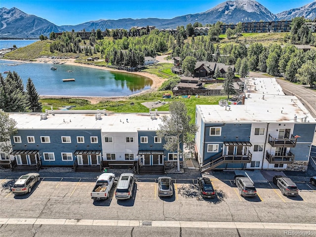 birds eye view of property with a water and mountain view