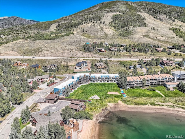 drone / aerial view featuring a water and mountain view