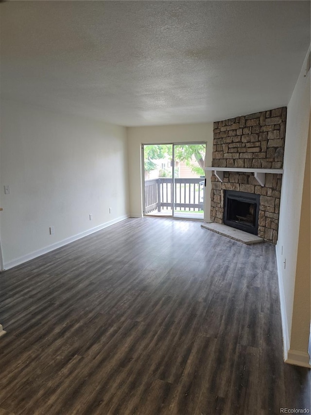 1840 S Pitkin Cir Unit A, Aurora, CO 80017 - unfurnished living room featuring dark wood-style flooring, a textured ceiling, and a fireplace