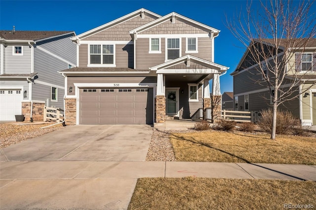 craftsman house featuring concrete driveway, fence, a garage, and stone siding