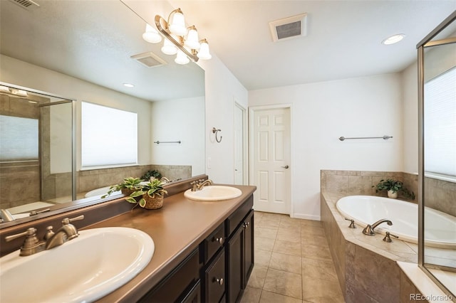 bathroom featuring plenty of natural light, visible vents, and a sink