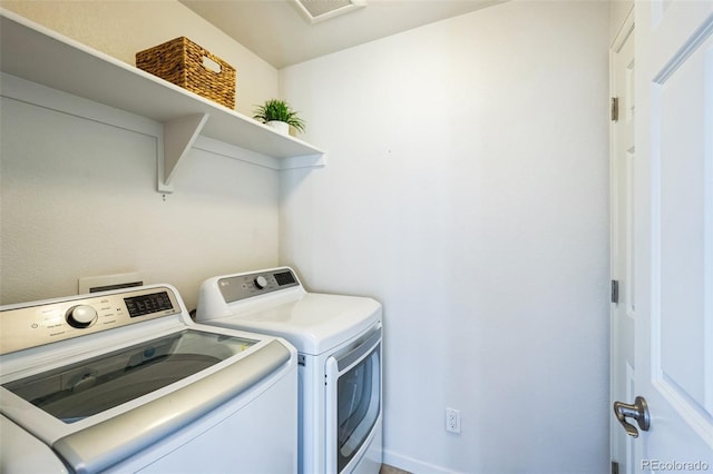 laundry room featuring laundry area, visible vents, and washing machine and clothes dryer