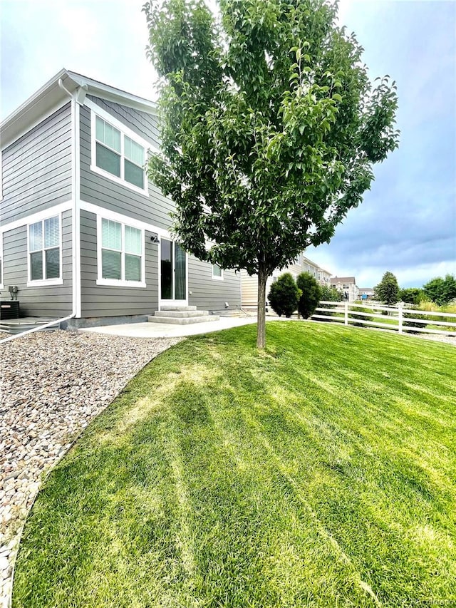 view of yard featuring a patio, fence, and entry steps