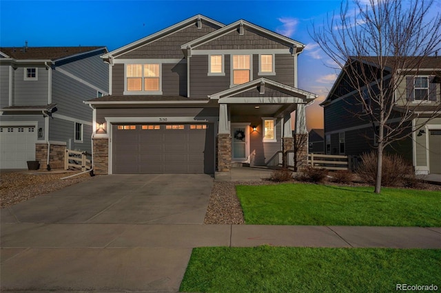 craftsman house featuring fence, a garage, driveway, and a lawn